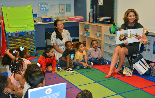 First Lady reading to preschool children in a classroom.